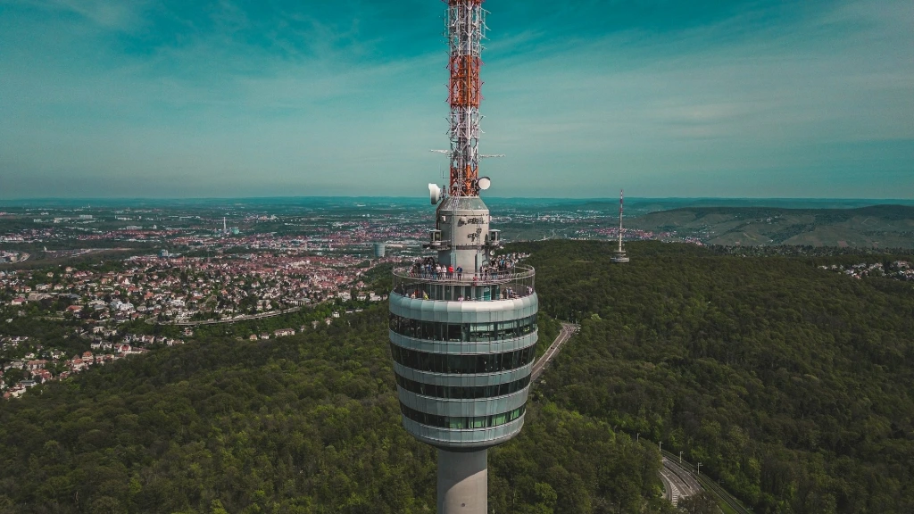a very tall tower sitting in the middle of a forest